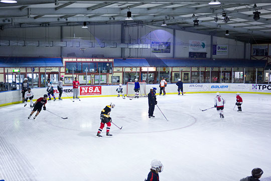 Participants receiving instruction at the Learn to Play hockey school.