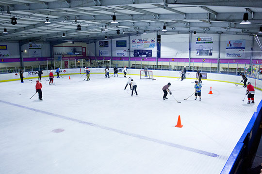 Participants receiving instruction at the Learn to Play hockey school.