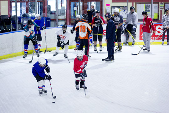 Participants receiving instruction at the Learn to Play hockey school.